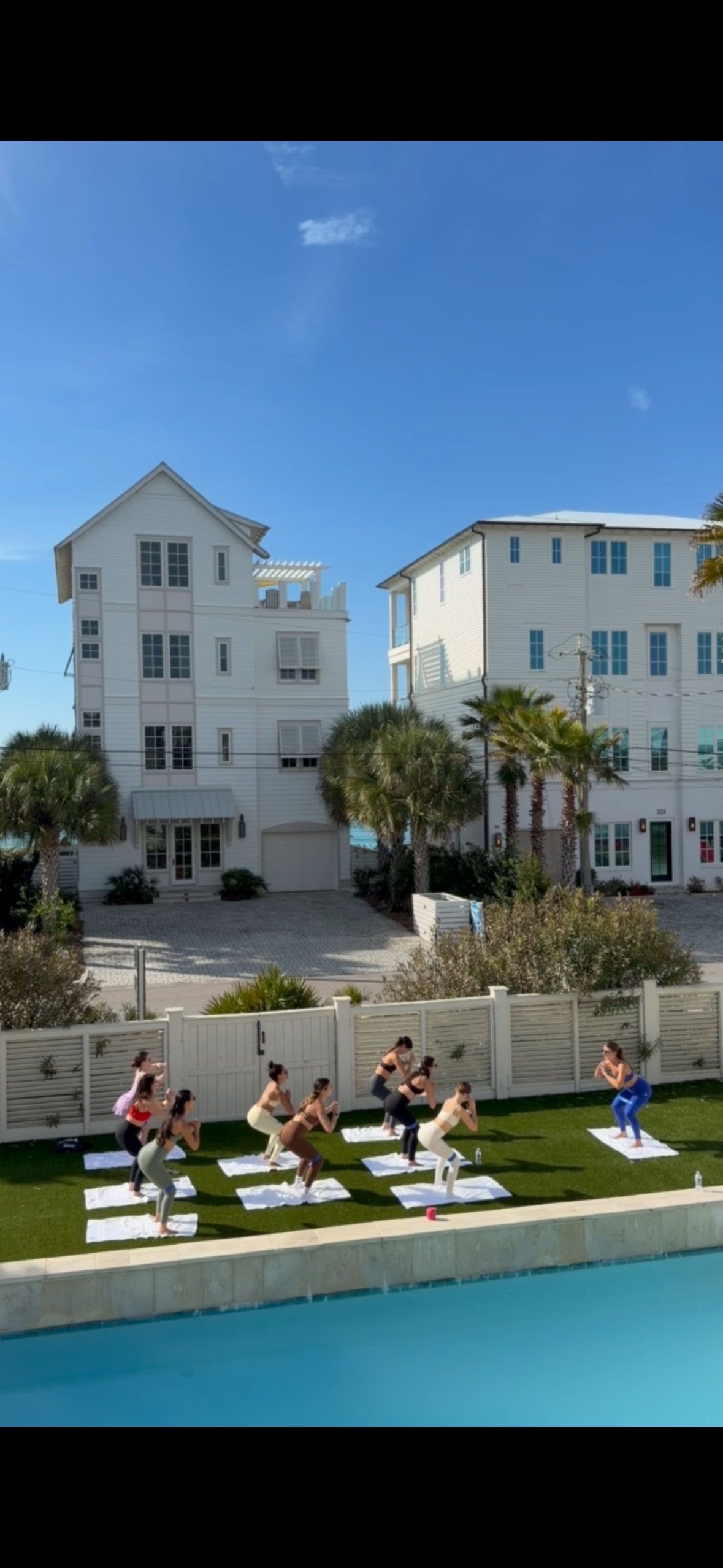 Group Pilates session poolside